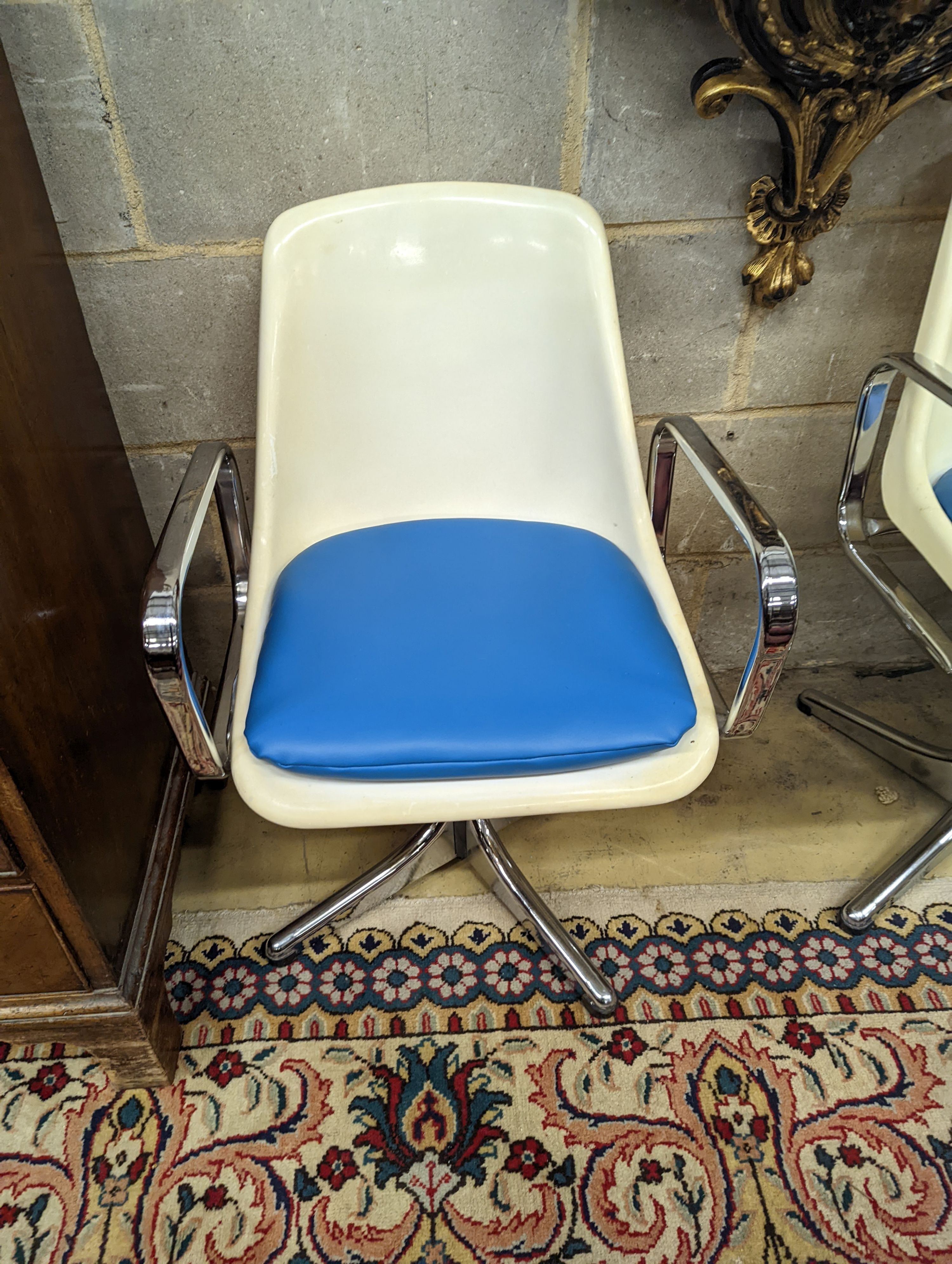 A pair of mid century Tulip style swivel chairs.